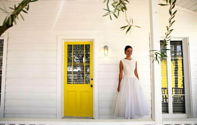 Bride infront of yellow door
