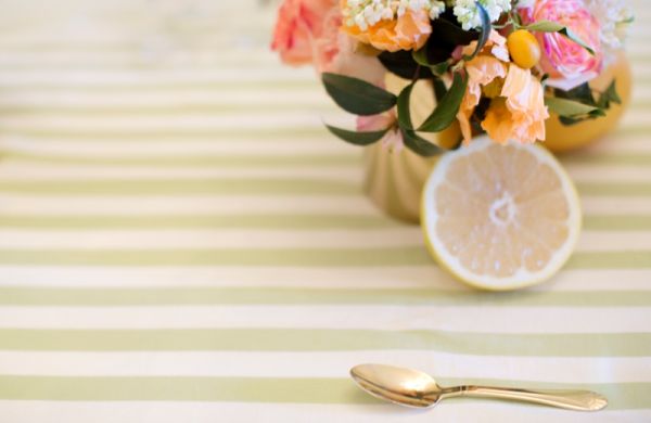 Citrus Bridal Shower, lemon, gold spoon, green stripe tablecloth, gold vase, floral arrangement