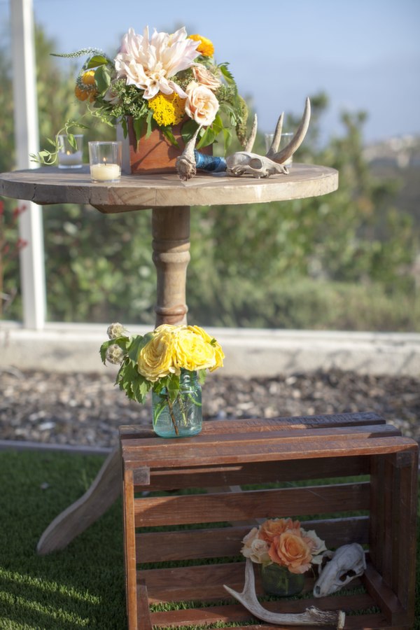 texan going away party, florals, orange, peach, distressed wood, votives, skull, outdoors