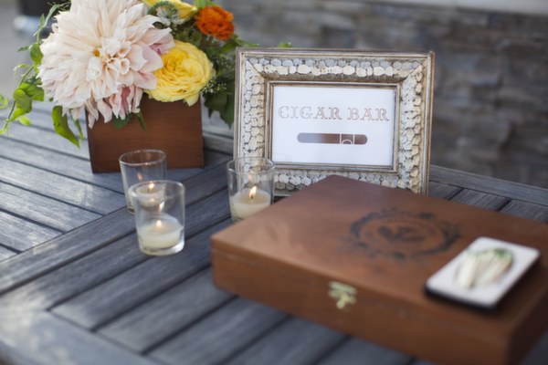 texan going away party, florals, peach, yellow, orange, cigar bar, frame, cigar box, wood, votives